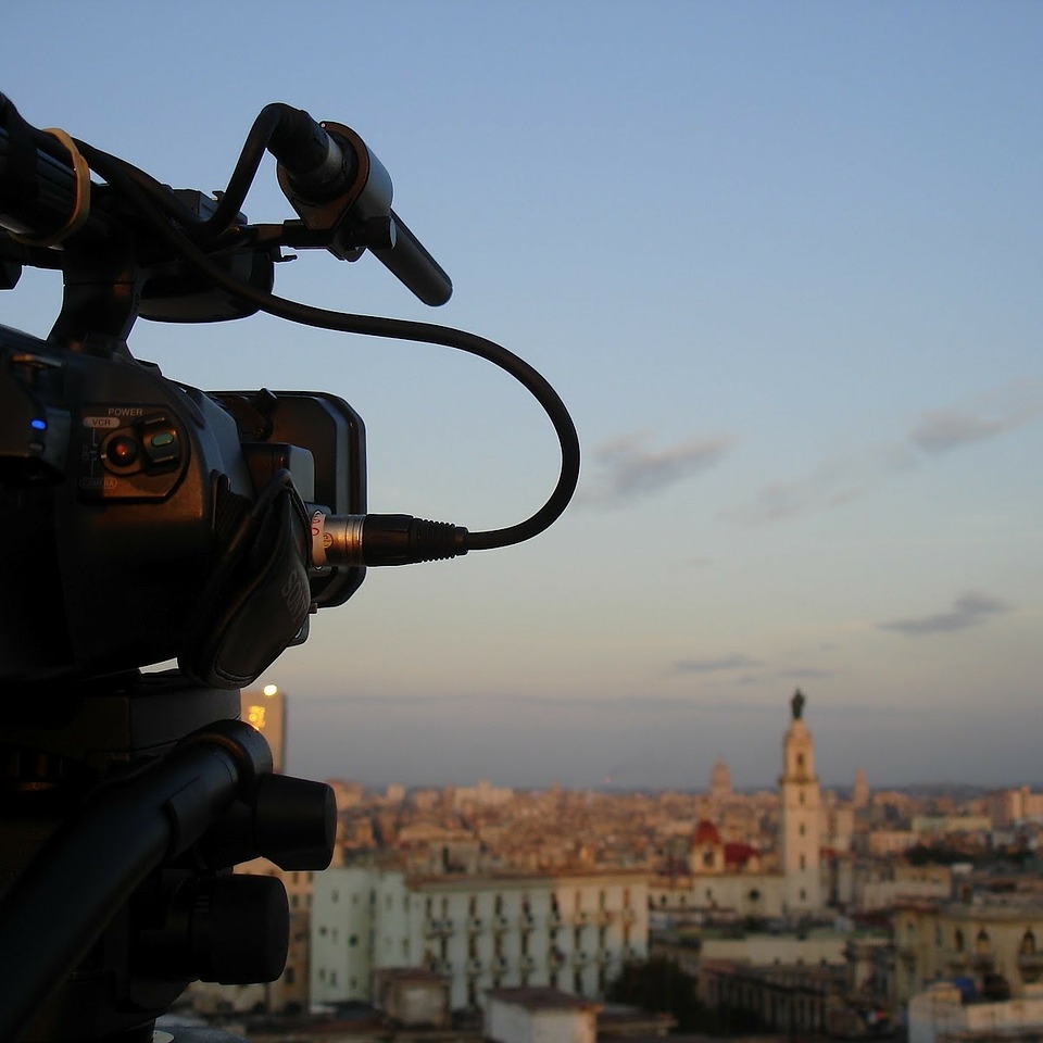 Silhouette of a film camera pointed towards the Havana skyline